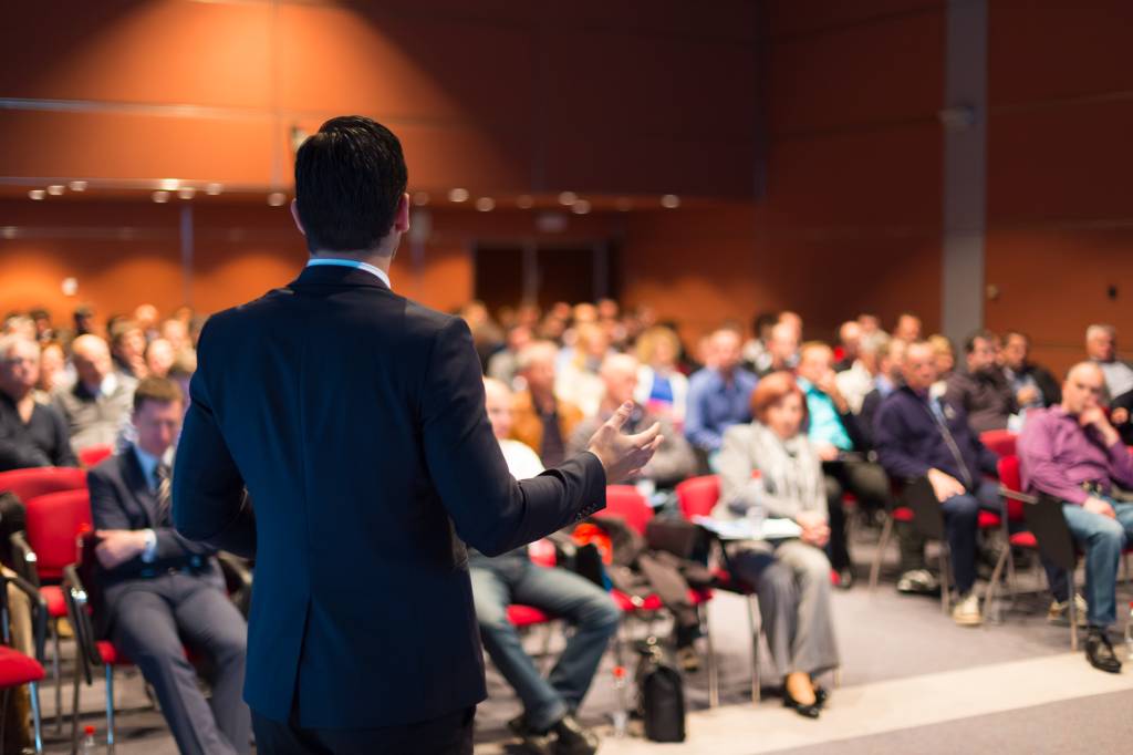 A man speaking at a business conference A man speaking at a business conference
